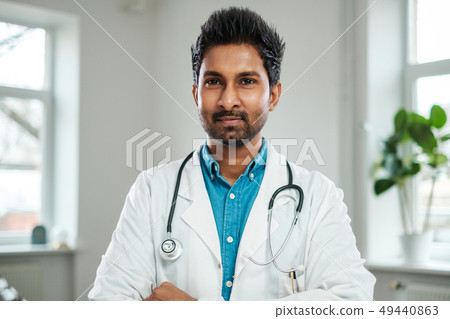 Indian doctor with stethoscope around neck in his office Indian doctor with stethoscope around neck in his office 49440863