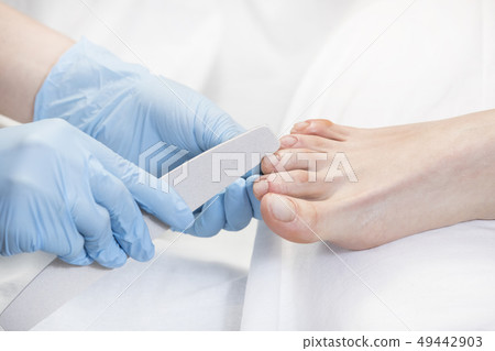 Process of pedicure of female legs at beauty salon Process of pedicure of female legs at beauty salon 49442903