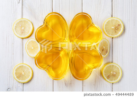 Yellow lemon jelly jello in heart shaped glass Yellow lemon jelly jello in heart shaped glass 49444489