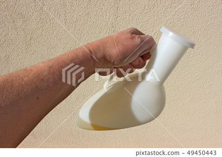The Doctor checks the color and amount of urine in The Doctor checks the color and amount of urine in 49450443