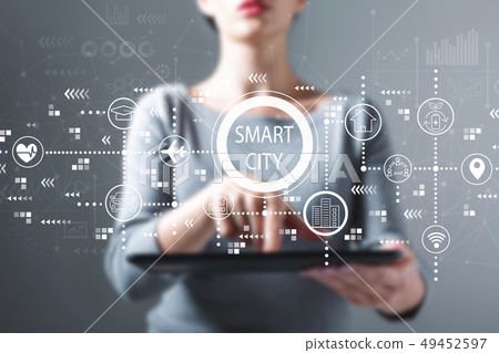 Smart city concept with woman using a tablet 49452597