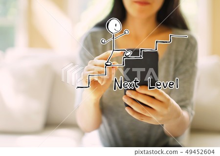 Next level concept with woman using a smartphone Next level concept with woman using a smartphone 49452604