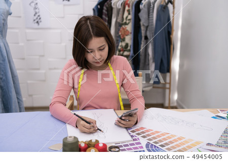 Designer concept. The dressmaker is designing an 49454005