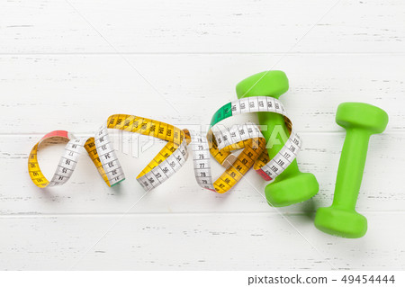 Fitness concept. Dumbbells and tape measure Fitness concept. Dumbbells and tape measure 49454444