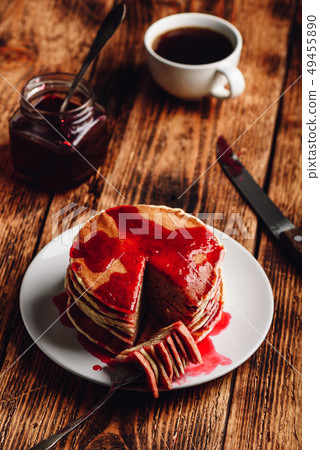 Stack of american pancakes with red berry jam 49455890
