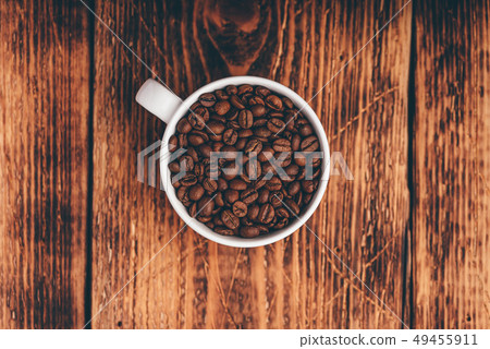Roasted coffee beans in white cup Roasted coffee beans in white cup 49455911