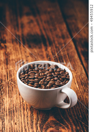 Roasted coffee beans in white cup 49455912
