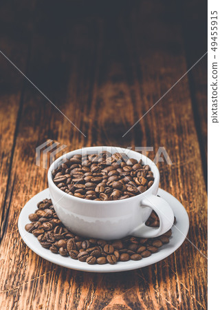 Cup full of roasted coffee beans Cup full of roasted coffee beans 49455915