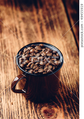 Mug full of roasted coffee beans Mug full of roasted coffee beans 49455919