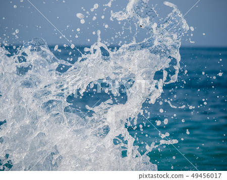 Splashes of water against the sea 49456017