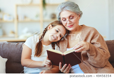 happy family grandmother reading to granddaughter 49456354