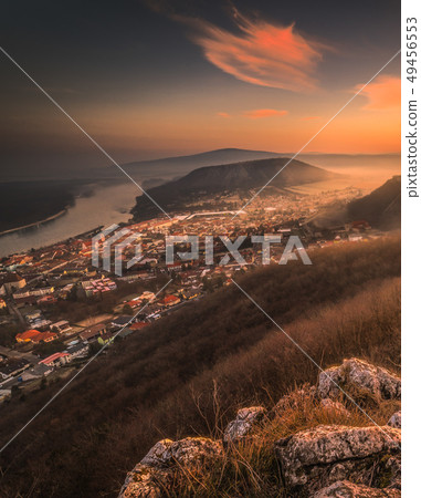 View of a Small City near a River at Sunrise View of a Small City near a River at Sunrise 49456553