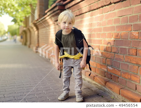 Student with large backpack near the school Student with large backpack near the school 49456554