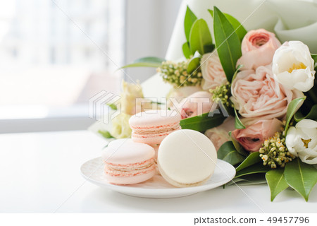 Elegant sweet macarons and pastel colored beige flowers 49457796