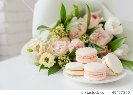 Elegant sweet macarons and pastel colored beige flowers 49457800