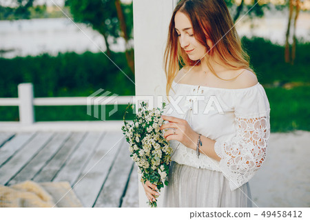 Young and pretty girl in a summer park 49458412