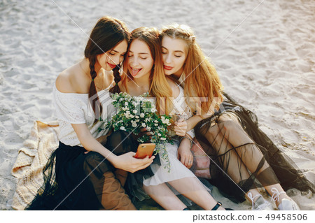 Three pretty girls in a summer park Three pretty girls in a summer park 49458506