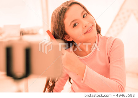Delighted nice girl doing a new hairstyle Delighted nice girl doing a new hairstyle 49463598