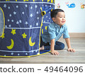 Happy little boy having fun with a play tent at 49464096