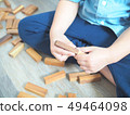 Close up of kid's hand playing with wooden blocks 49464098