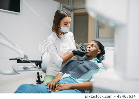 Dentist examines the teeth, dental clinic 49465634