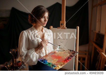 Female painter with color palette and brush 49465699