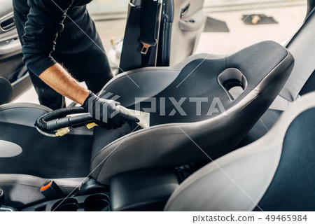 Carwash service, male worker removes dust and dirt 49465984