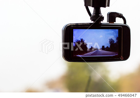 Picture road and tree on camera in car. 49466047