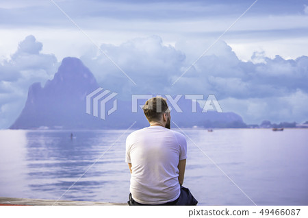 Tourists watching the sea with fishing boats. Tourists watching the sea with fishing boats. 49466087