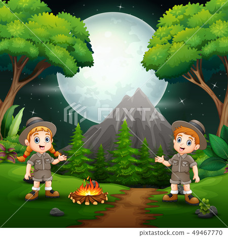 Happy scout boy and girl with a campfire at night Happy scout boy and girl with a campfire at night 49467770