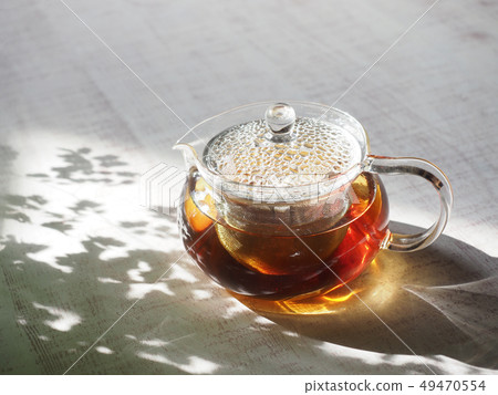 Glass teapot and green tea 49470554