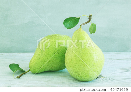 Juicy flavorful green pears on gray wooden table. 49471639