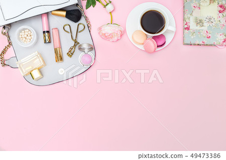 Cosmetics and accessories on a pink background. 49473386