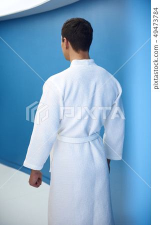 Muscular young man in corridor of spa center Muscular young man in corridor of spa center 49473784