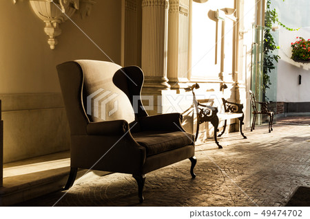 An old-fashioned armchair in the shade. Antique 49474702