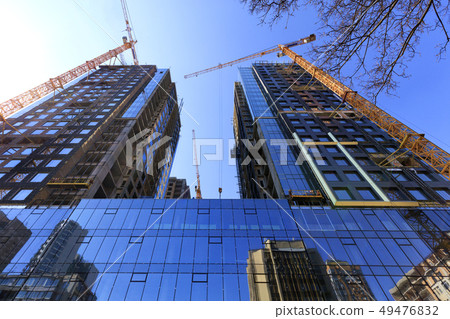 The glass facade, a reflection of the blue sky The glass facade, a reflection of the blue sky 49476832