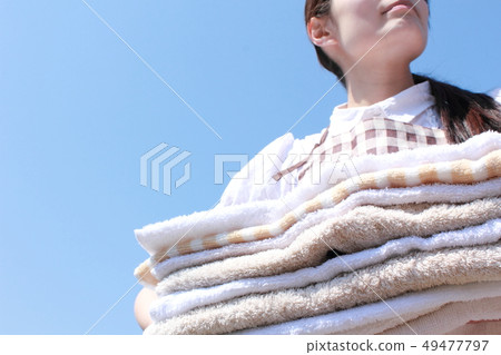 One woman (washing housework housewife apron laundry cleaning everyday life lifestyle faceless) One woman (washing housework housewife apron laundry cleaning everyday life lifestyle faceless) 49477797