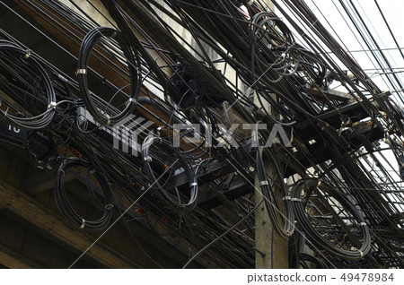 Messy high voltage electric wire in city 49478984