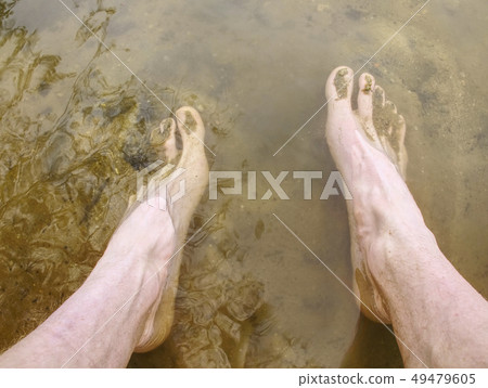 Washing mud from body after extreme race run. Washing mud from body after extreme race run. 49479605