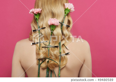 Close up blonde woman with carnation in hairs Close up blonde woman with carnation in hairs 49480589