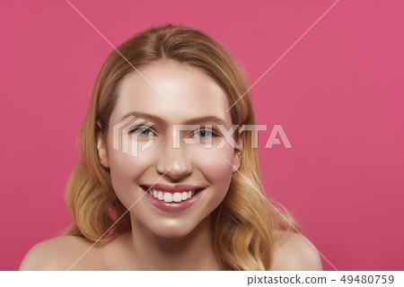 Sincere smiling blonde woman isolated on pink Sincere smiling blonde woman isolated on pink 49480759