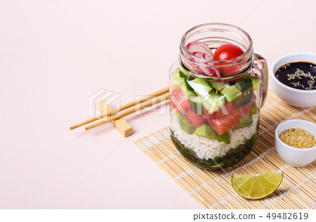 Hawaiian salmon poke salad in glass jar with rice Hawaiian salmon poke salad in glass jar with rice 49482619