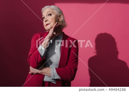 Waist up of elegant senior lady with modern makeup posing in studio 49484286