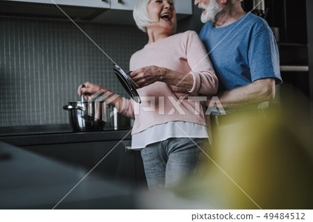 Happy laughing senior couple cooking on kitchen 49484512