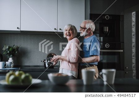 Elder couple preparing dinner together on kitchen 49484517