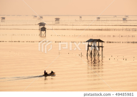 Silhouette fisherman in boat in morning 49485981