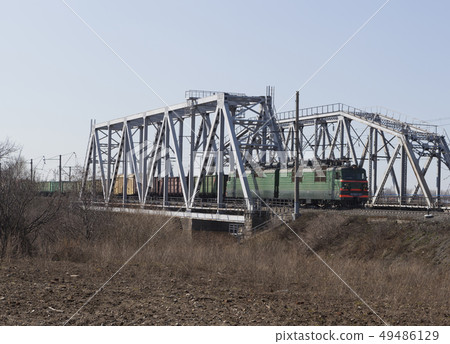 Cargo train rides on the railway bridge Cargo train rides on the railway bridge 49486129