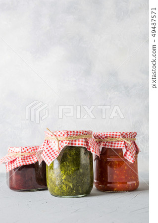 Various types of canned sauce for serving to meat. 49487571