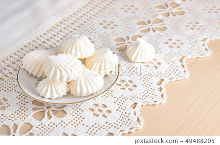 Meringue on a lacy cloth. Meringue on a lacy cloth. 49488205