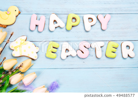 Delicious Easter cookies background. Eggs with different pattern icing on blue wooden background 49488577